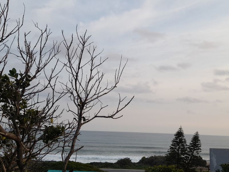 A scenic view of the ocean and coastline from the property, showcasing the natural landscape and horizon.