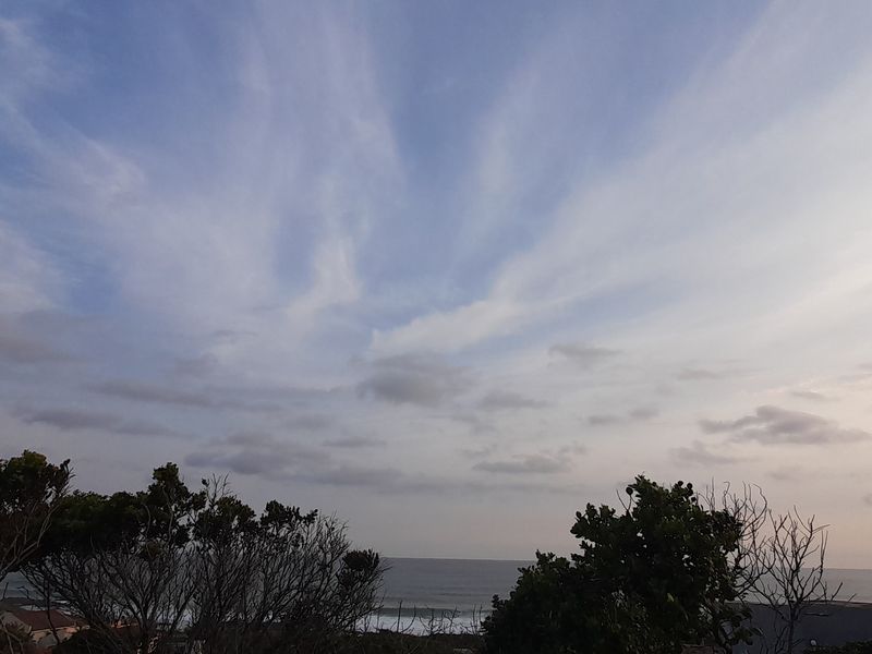 A scenic view of the horizon and coastline, capturing the natural landscape and sky from the property.
