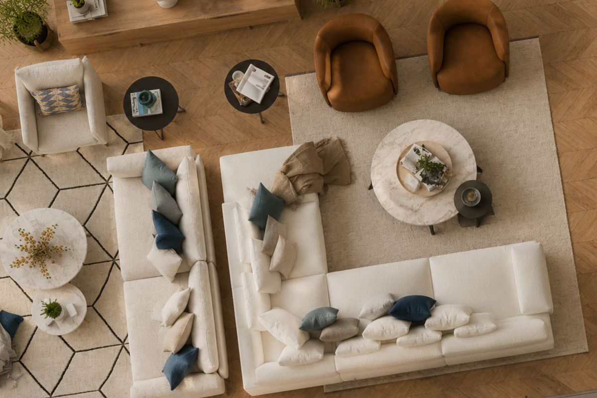 An overhead view of a spacious living area featuring high-quality herringbone hardwood flooring and a well-appointed seating arrangement.