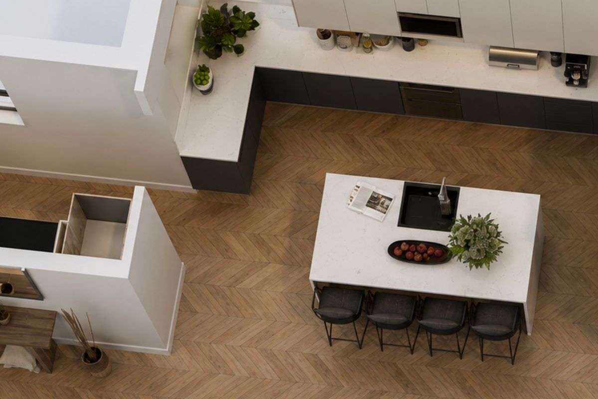 Modern kitchen featuring a large central island with stone countertops, sleek cabinetry, and elegant herringbone timber flooring in an open-plan layout.