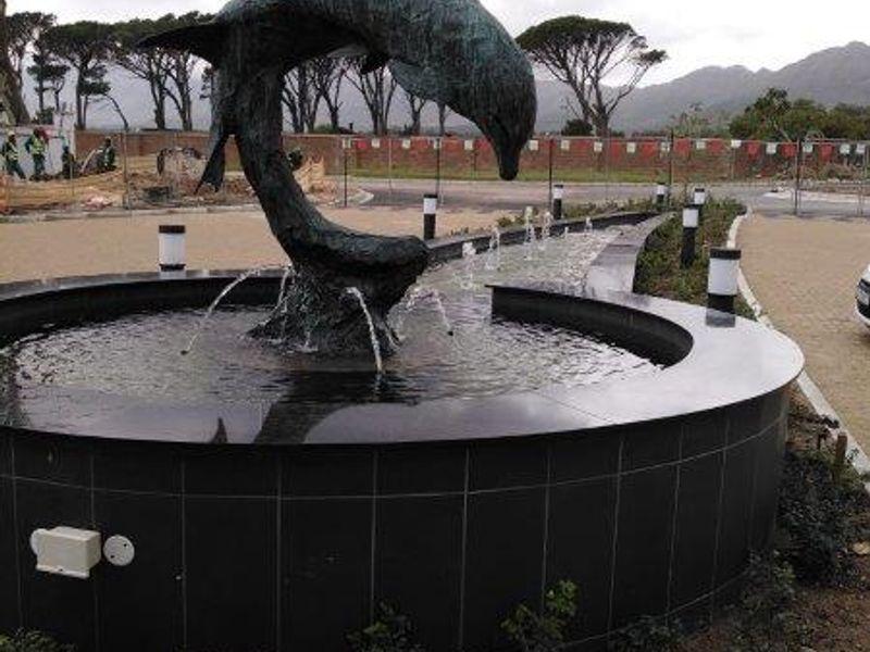 A decorative dolphin water fountain feature located in the front entrance area of the property.