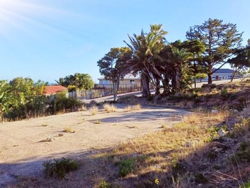 A vacant residential plot featuring an existing concrete slab, mature trees, and perimeter fencing, offering potential for future development.