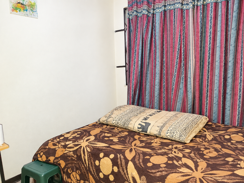 A bedroom space featuring a window with installed curtain rails and curtains.