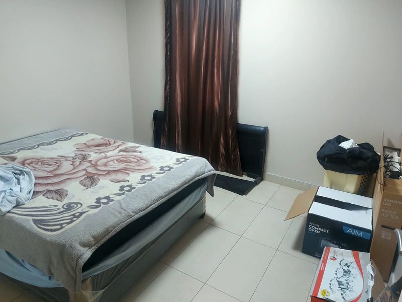A functional bedroom featuring neutral wall finishes and tiled flooring, providing a blank canvas for potential interior design updates.