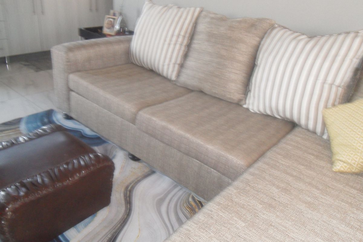 A view of a living area featuring tiled flooring and built-in cabinetry in the background.
