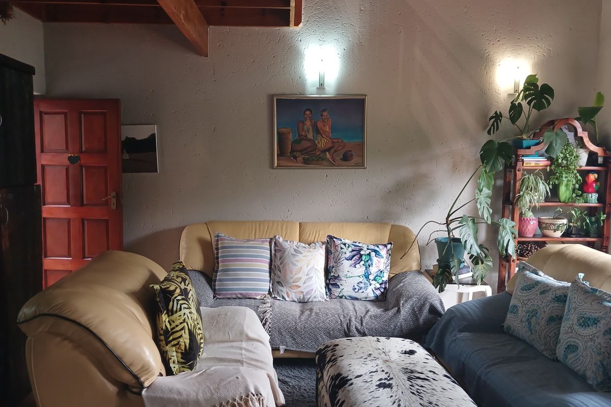 A cozy living room featuring exposed timber ceiling beams and textured walls, creating a warm and inviting atmosphere.