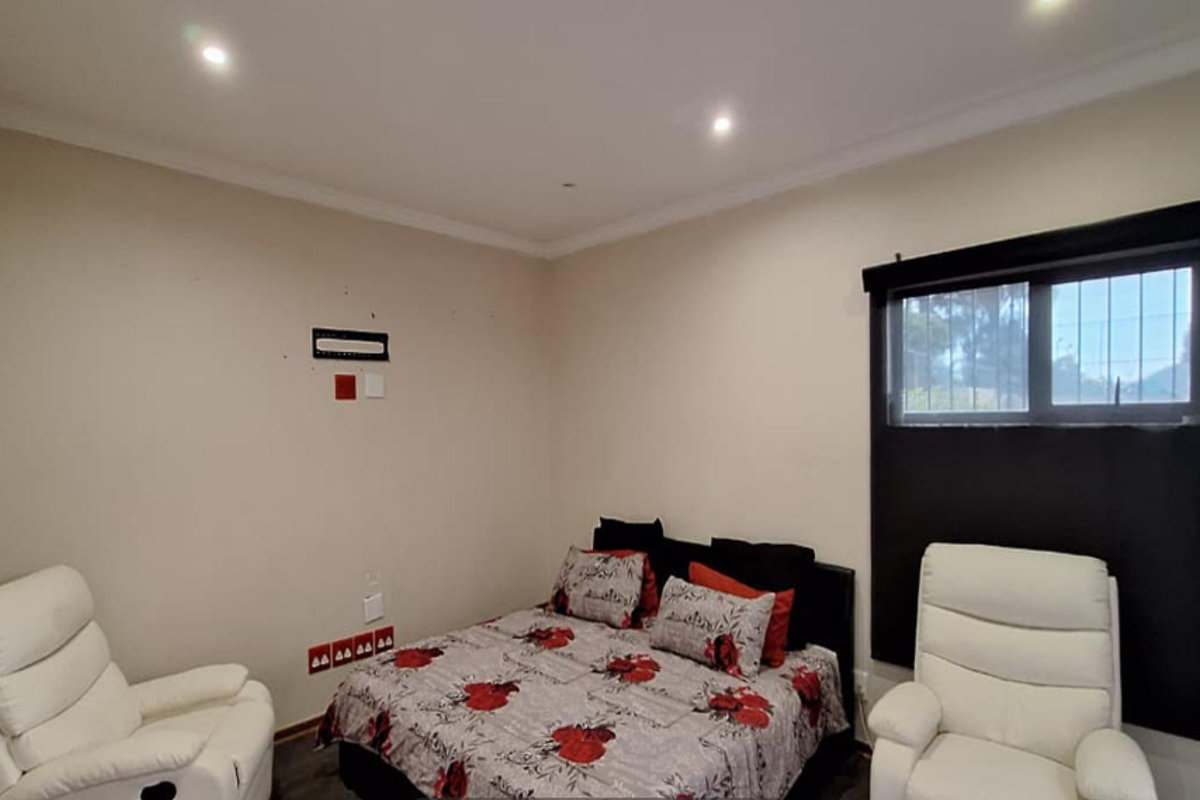 A bedroom featuring recessed ceiling lighting, dark window blinds, and neutral wall finishes.