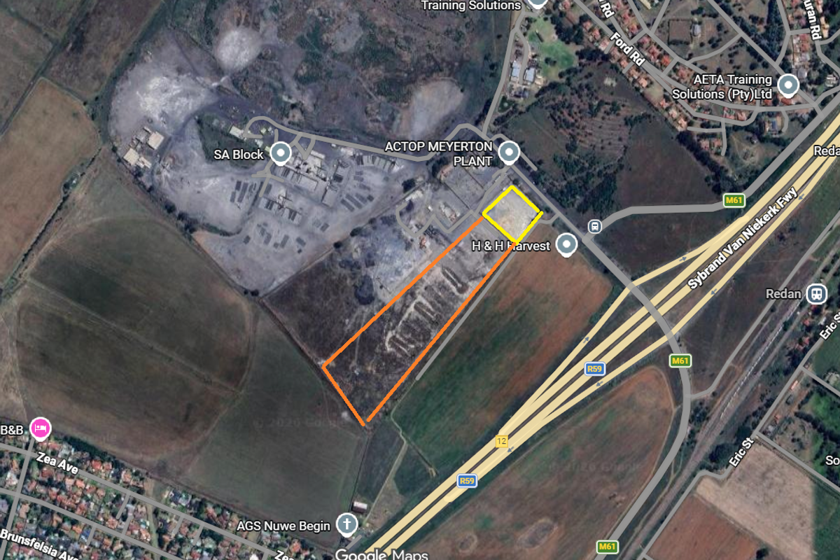 Aerial view of an industrial land parcel located near major transport routes and existing industrial facilities.