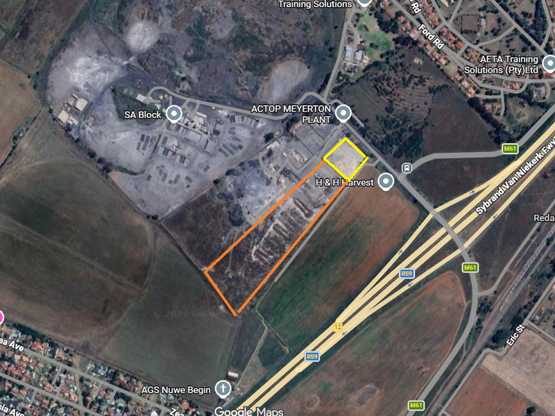 Aerial view of an industrial land parcel located near major transport routes and existing industrial facilities.