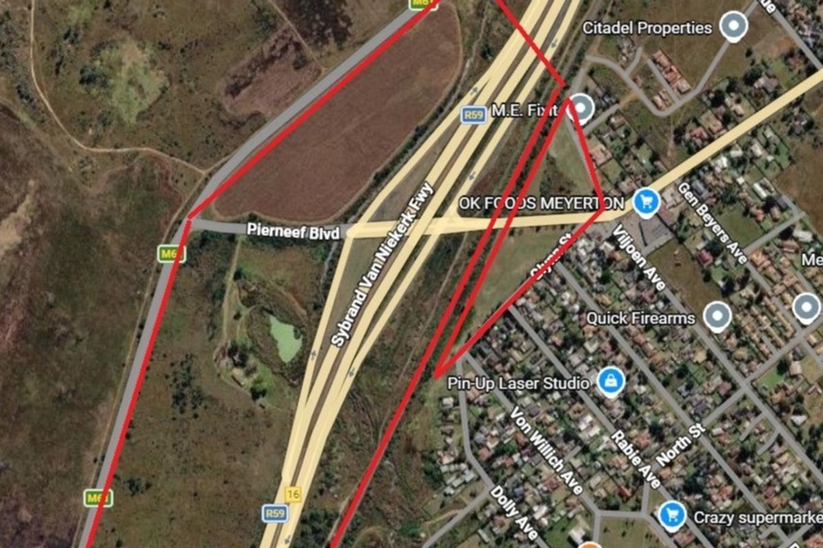An aerial satellite view showing the property boundaries outlined in red, situated near major road infrastructure and local commercial amenities.