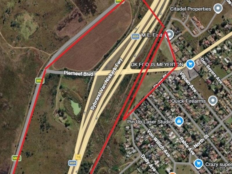 An aerial satellite view showing the property boundaries outlined in red, situated near major road infrastructure and local commercial amenities.