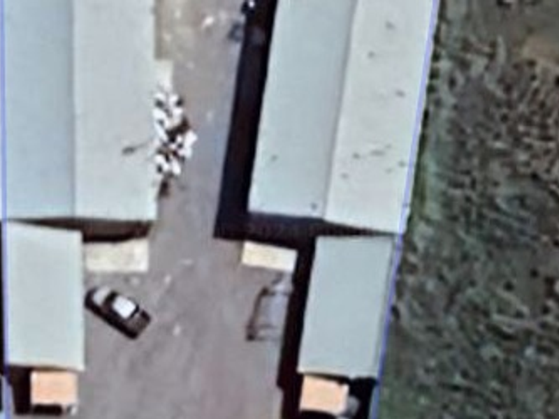 Aerial view of an industrial property showing the layout of multiple warehouse structures and surrounding site area.