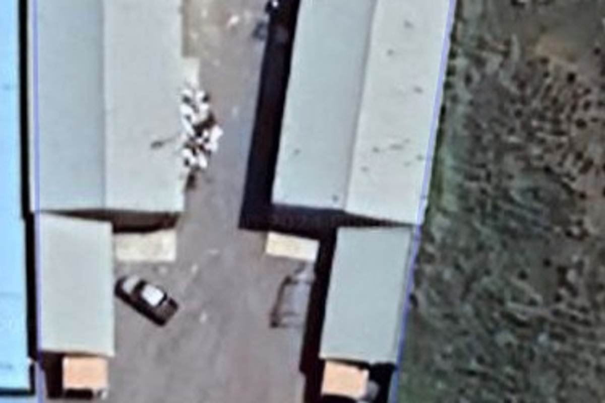 Aerial view of an industrial property showing the layout of multiple warehouse structures and surrounding site area.