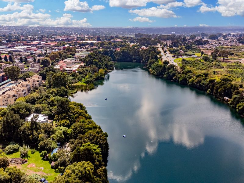 An aerial view showcasing the property's proximity to a large lake and surrounding natural landscape.