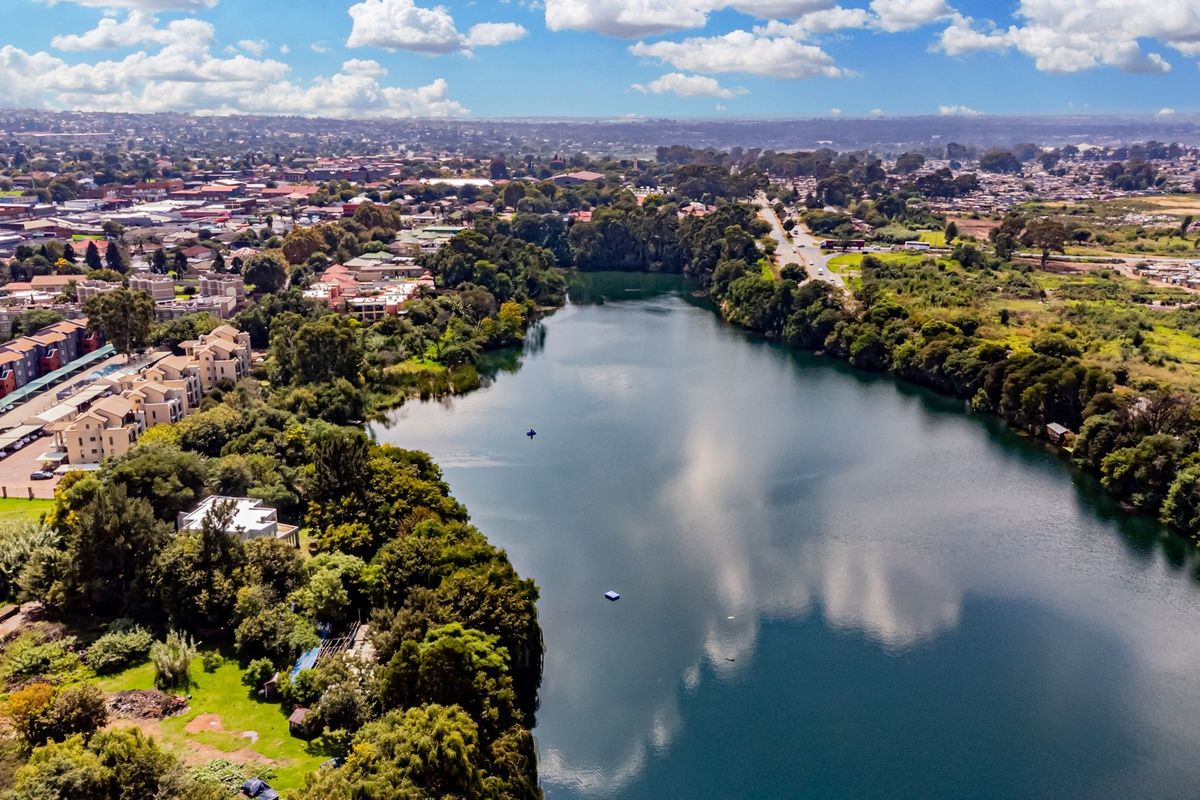 An aerial view showcasing the property's proximity to a large lake and surrounding natural landscape.
