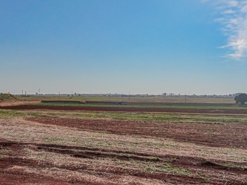 Expansive view of open agricultural land and fields, showcasing the vast potential of this small holding property.
