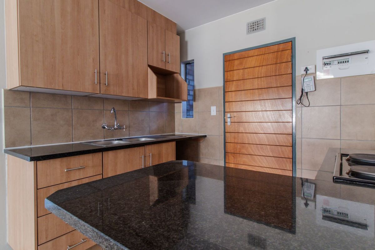 Modern Elegant Two Bedroom Apartment with Single Carport in Sought-After Route 82 Village 1 Complex - Photo 5