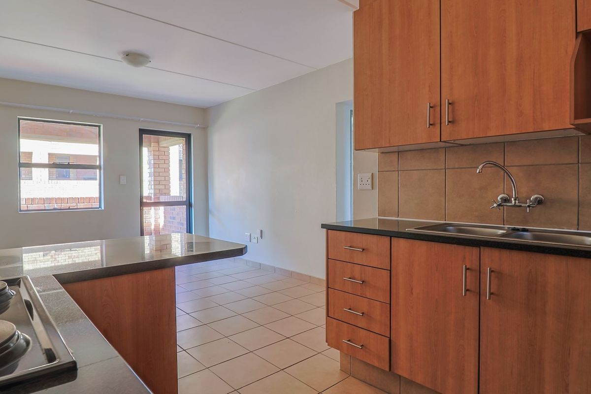 Modern Elegant Two Bedroom Apartment with Single Carport in Sought-After Route 82 Village 1 Complex - Photo 2