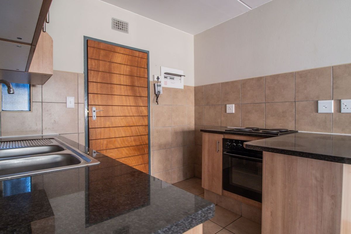 Modern Elegant Two Bedroom Apartment with Single Carport in Sought-After Route 82 Village 1 Complex - Photo 4