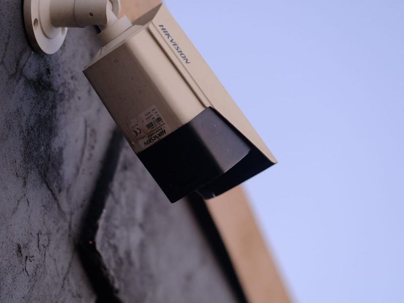 A wall-mounted Hikvision security camera providing exterior surveillance for the property.