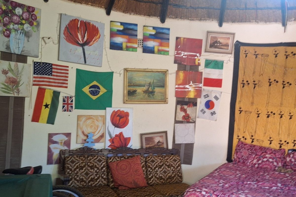 A bedroom space featuring a traditional thatched roof ceiling, providing a rustic aesthetic within the property.