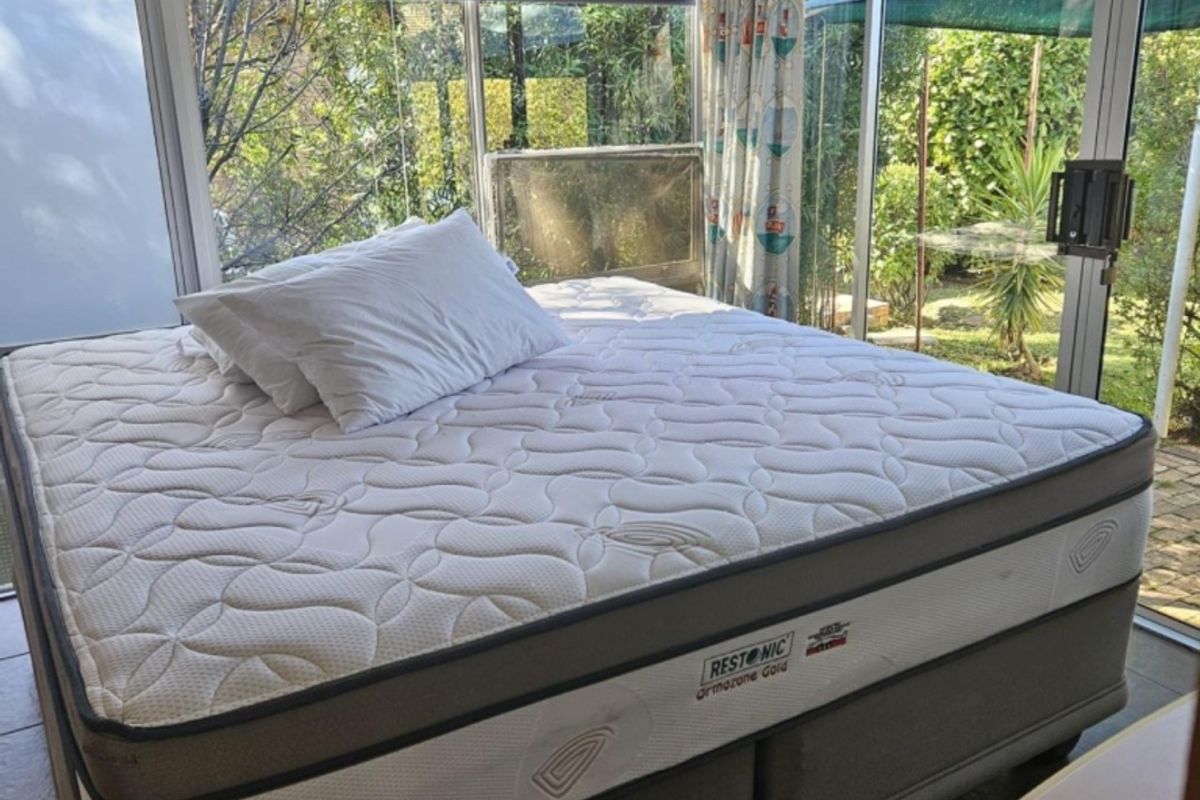 A bedroom space featuring large sliding glass doors that provide natural light and direct access to the garden area.
