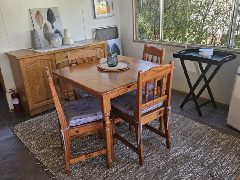 A functional dining area featuring tiled flooring and a large window that provides natural light.