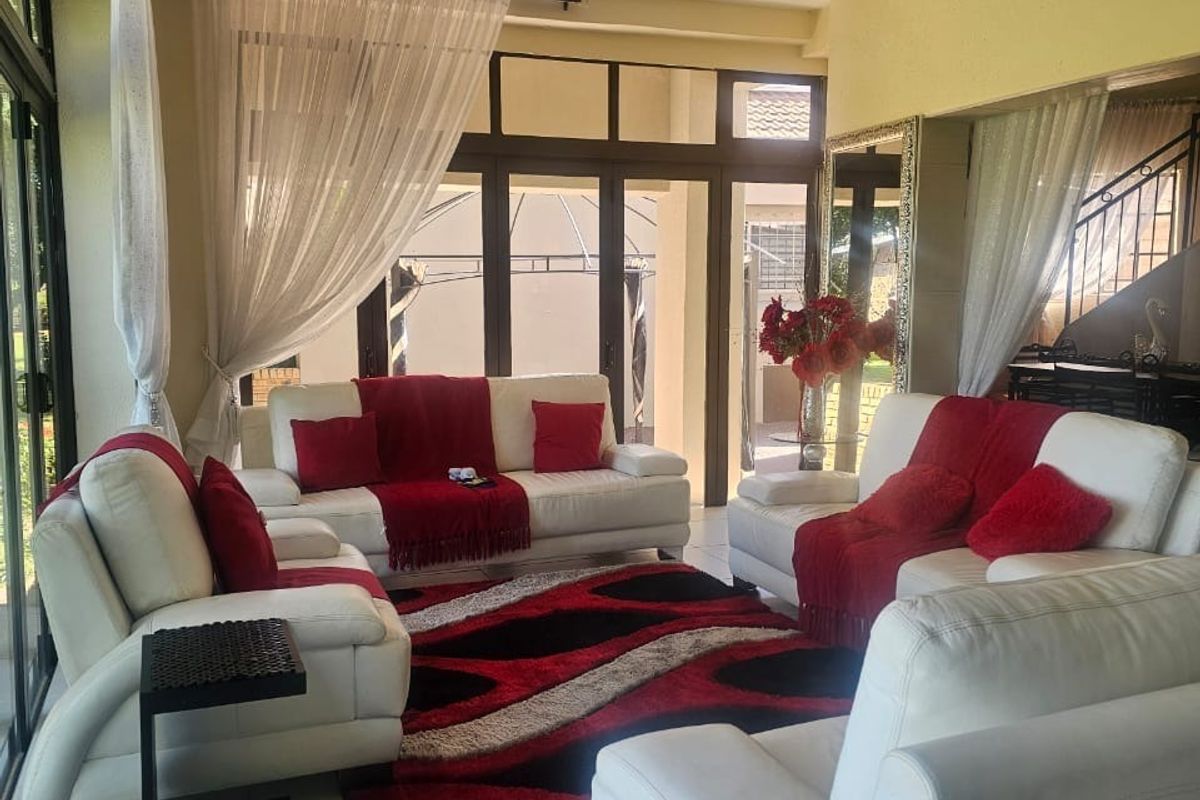 A bright living room featuring large glass sliding doors that provide ample natural light and direct access to the outdoor area.