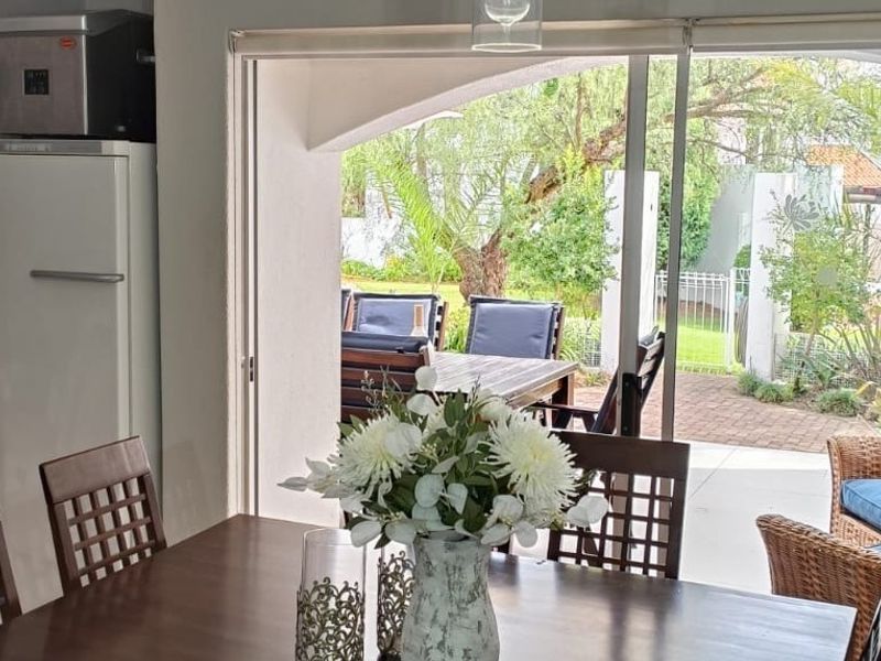Open plan living area featuring large sliding glass doors that provide seamless access to the outdoor patio and garden space.