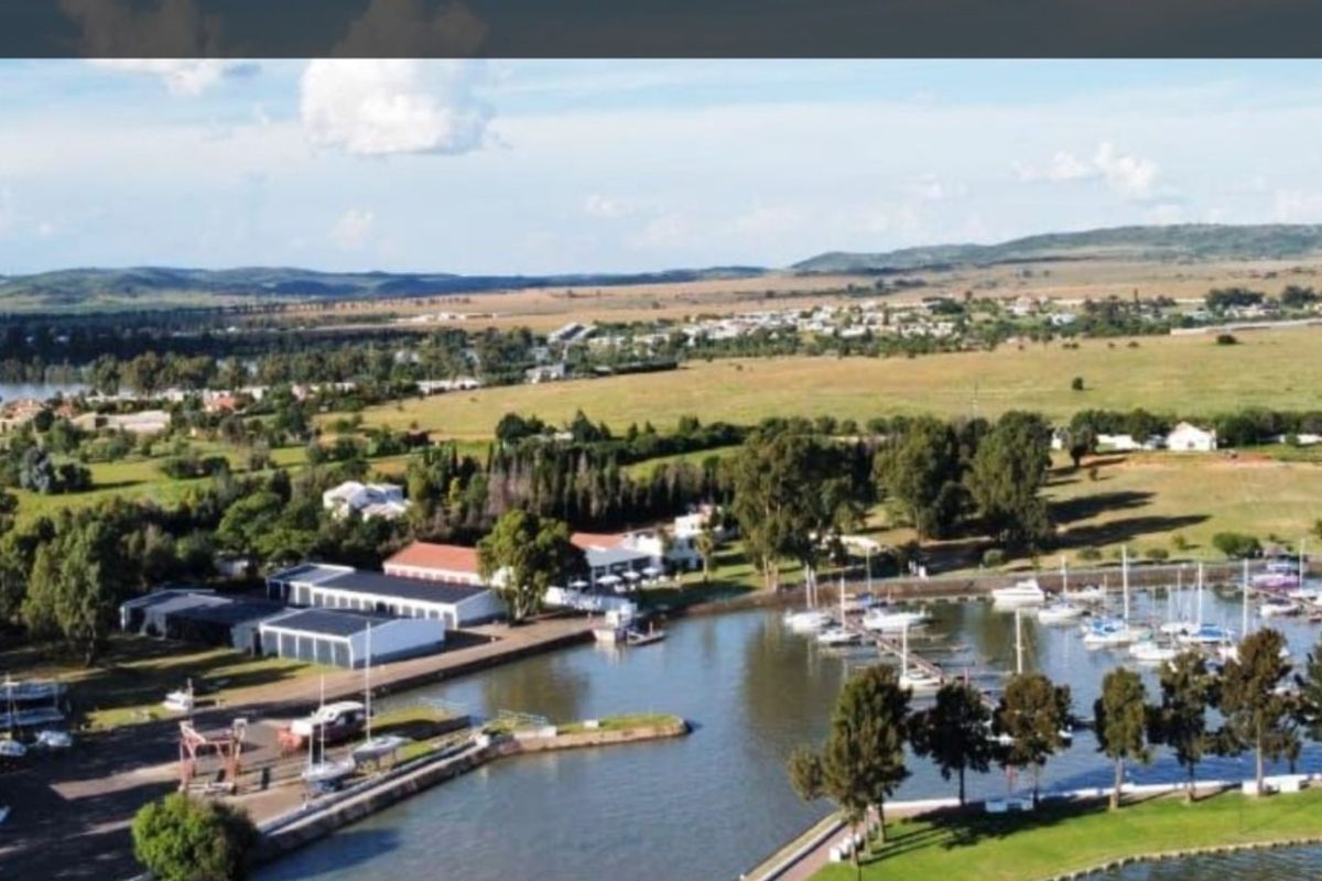 Aerial view of the property location featuring a marina, boat moorings, and surrounding landscaped grounds in a scenic waterfront setting.