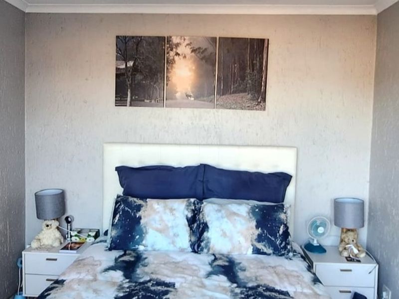 A bedroom featuring textured wall finishes and coving, providing a neutral base for interior design updates.