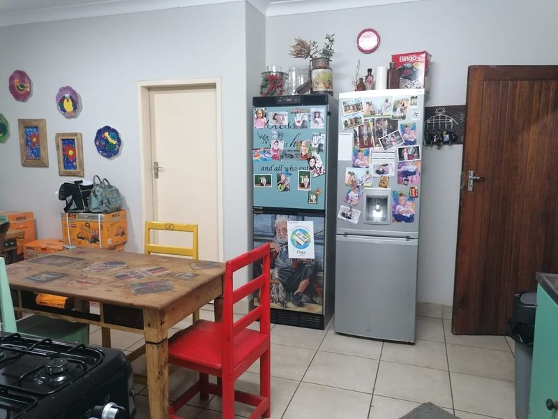 A functional kitchen area featuring tiled flooring and standard interior door access, providing a practical space for daily meal preparation.