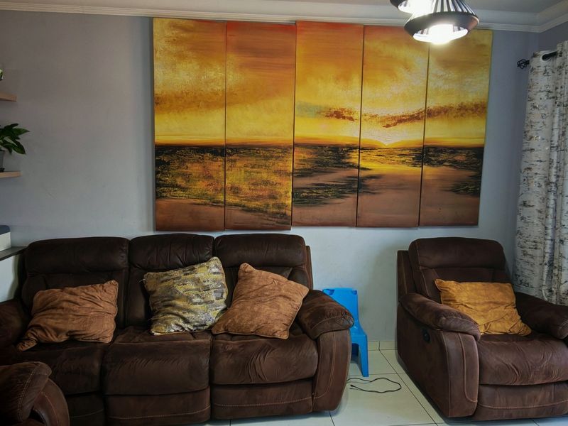 A comfortable living room area featuring tiled flooring and a sliding glass door providing access to an outdoor space.