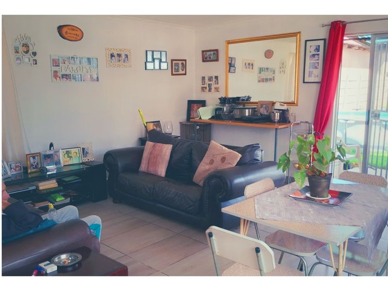 Open plan living and dining area featuring tiled flooring and a sliding glass door leading to the outdoor space.