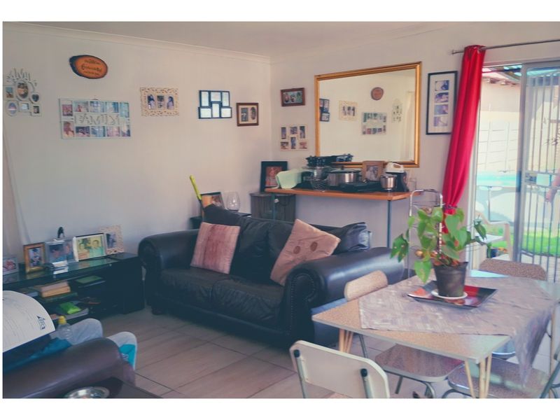 Open plan living and dining area featuring tiled flooring and a sliding glass door providing access to the outdoor space.