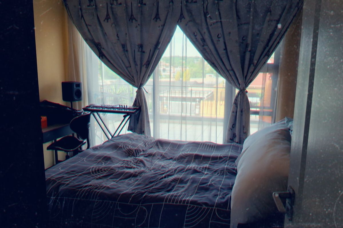 A bedroom featuring a large sliding glass door that provides natural light and direct access to an outdoor balcony area.