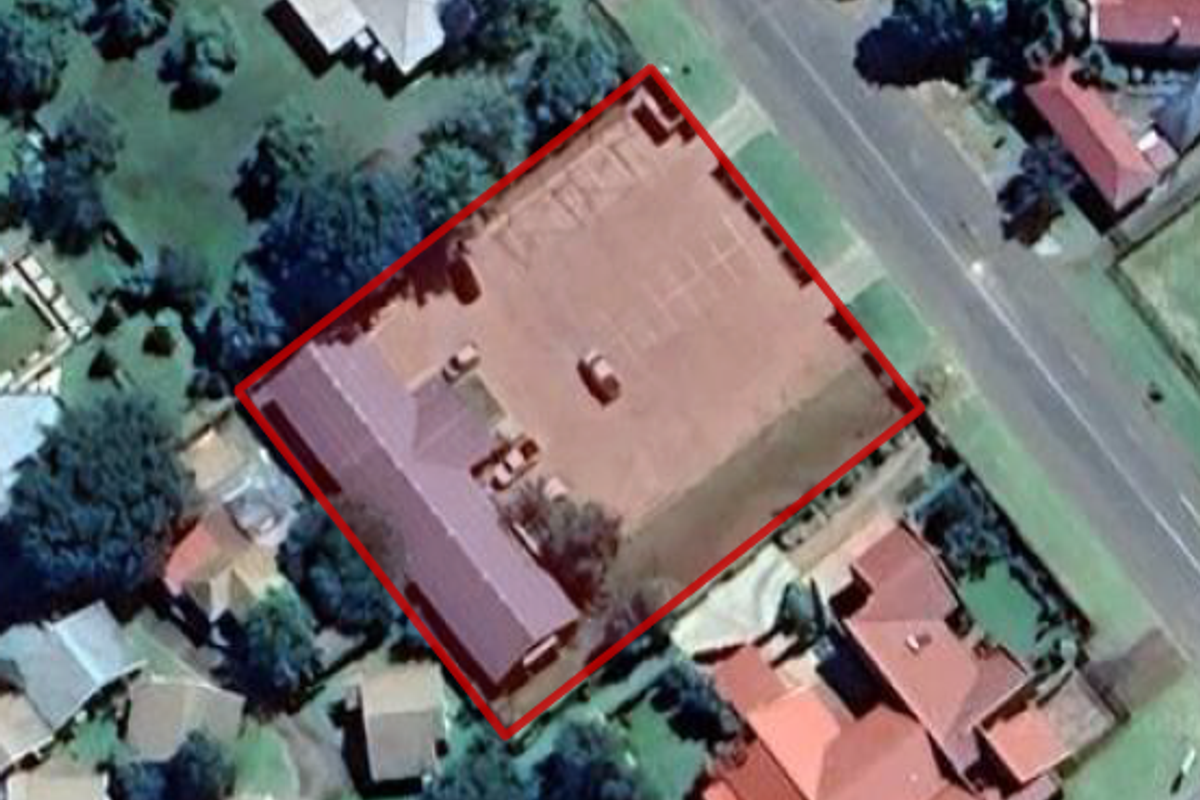 Aerial view of the office property showing the building footprint, parking area, and site boundaries.