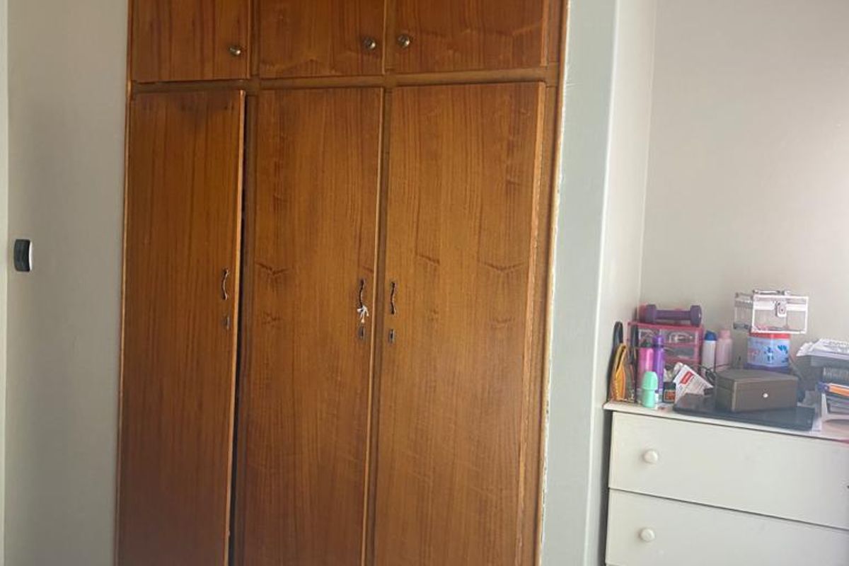 Bedroom featuring built-in wooden cupboards and a timber-clad ceiling.