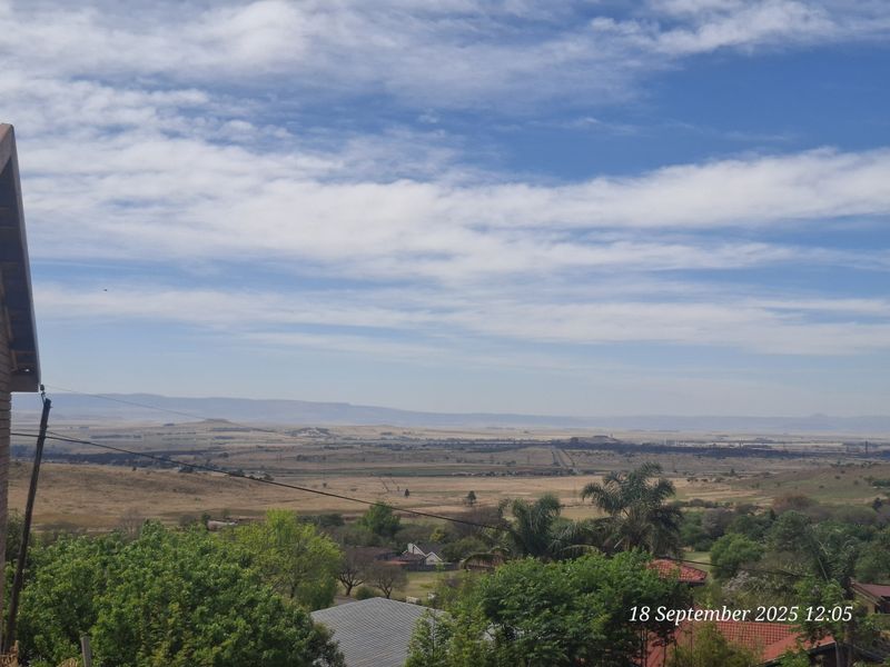 Expansive elevated landscape view overlooking the surrounding countryside and residential area.