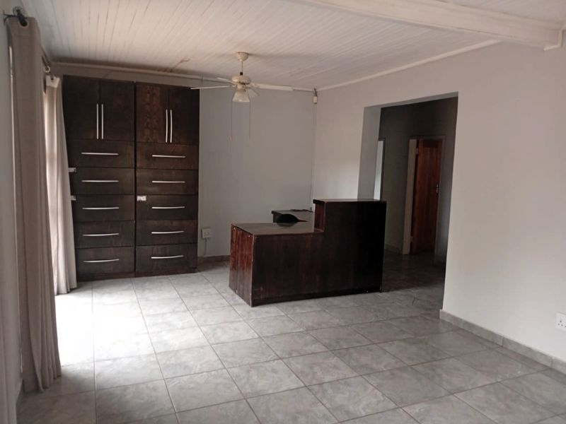 Office space featuring tiled flooring, a timber-look ceiling, ceiling fan, and built-in storage cabinetry.