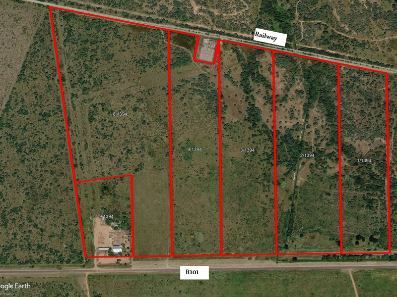 Aerial view of vacant commercial land parcels adjacent to the R101 road and a railway line, showing clear boundary demarcations.