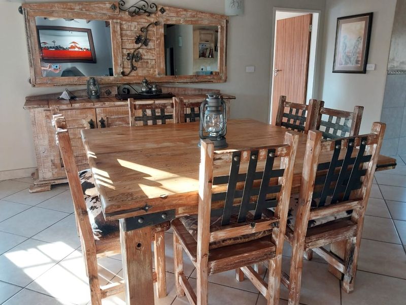 A dining room featuring tiled flooring and a rustic aesthetic, providing a functional space for meals.