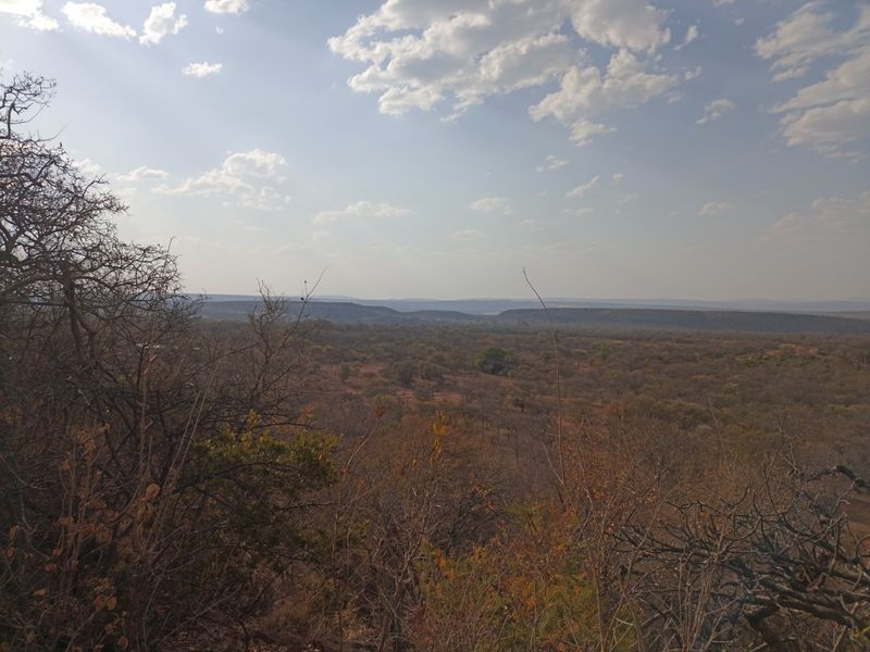 A scenic elevated landscape view overlooking the natural bushveld and surrounding terrain of the small holding.