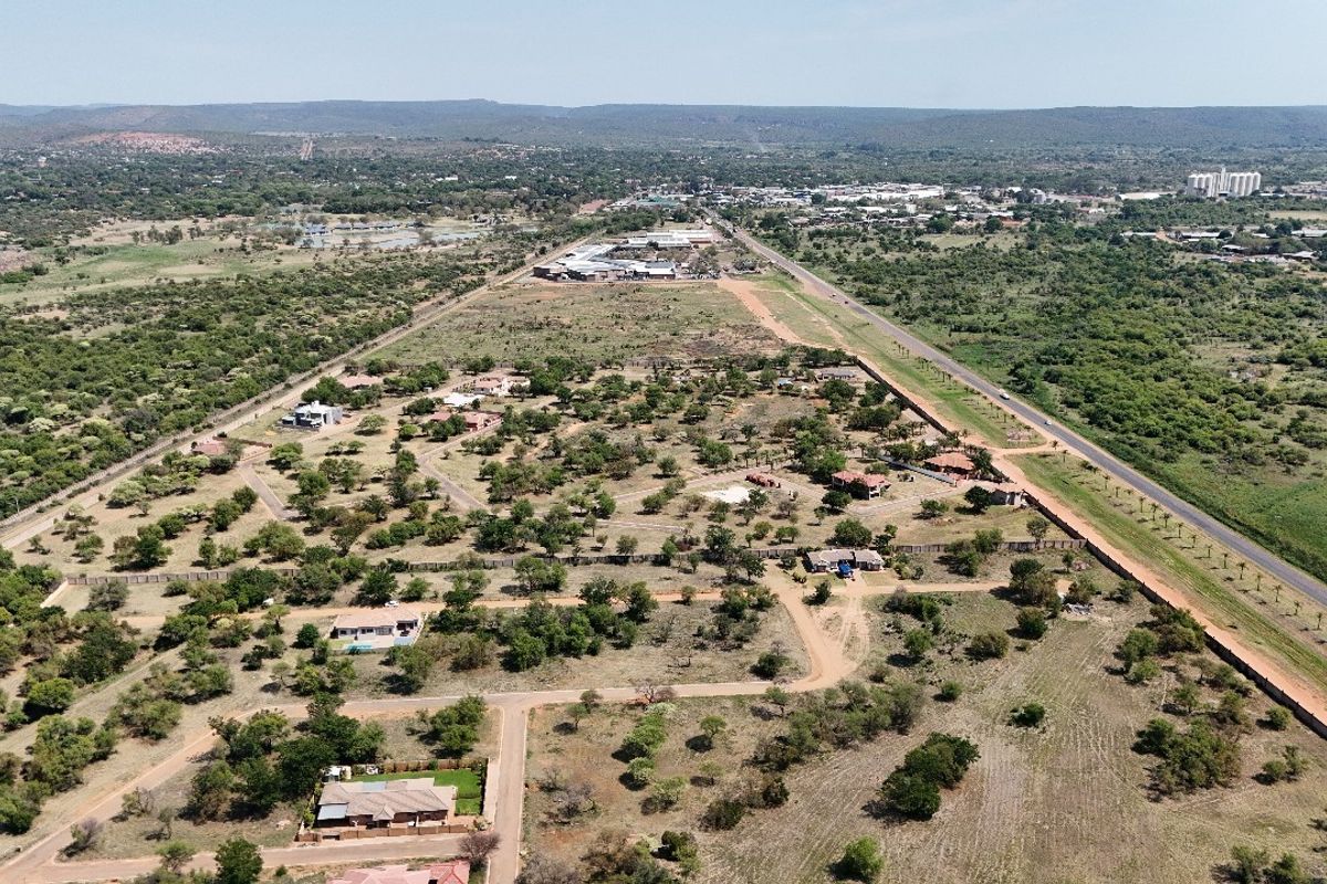 An aerial view of a residential estate featuring established vegetation, internal road infrastructure, and perimeter fencing within a semi-rural landscape.