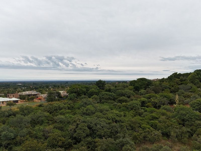 An aerial view of the vacant residential land featuring dense native vegetation and surrounding woodland landscape.