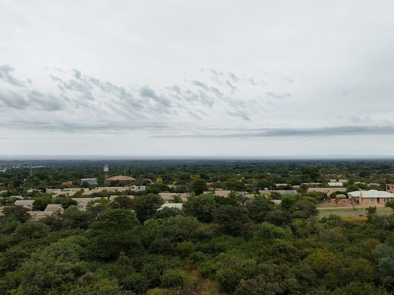 An aerial view of the surrounding residential neighborhood and landscape, showcasing the local area and vegetation.