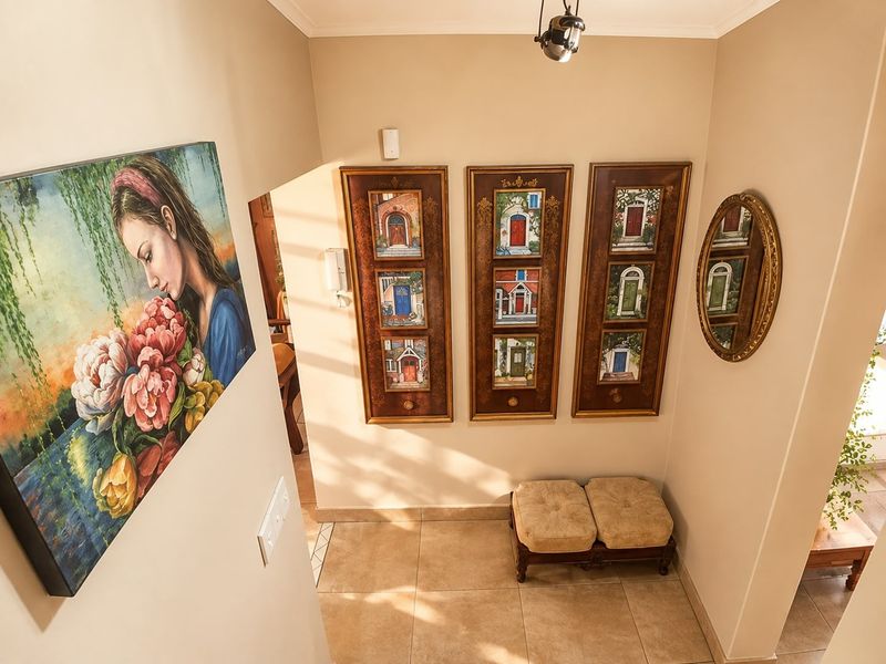 A welcoming entrance foyer featuring neutral tiled flooring, an intercom system, and warm ambient lighting.