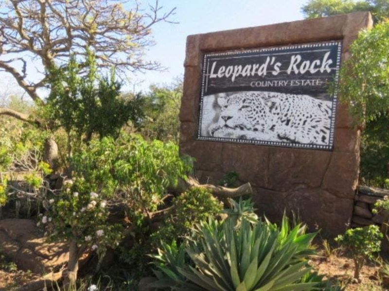 Entrance signage for Leopard's Rock Country Estate, featuring stone-clad monument signage set within a landscaped garden area.