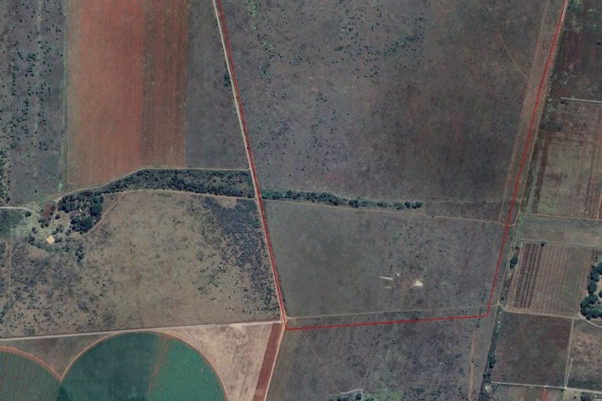 Aerial view of a large, undeveloped residential land parcel with clear boundary demarcations, suitable for future development or agricultural use.