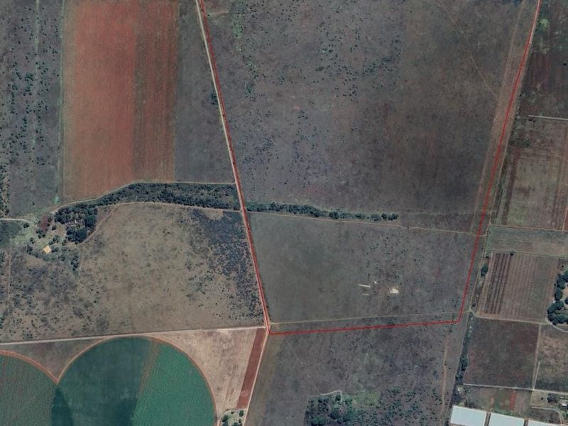 Aerial view of a large, undeveloped residential land parcel with clear boundary demarcations, suitable for future development or agricultural use.